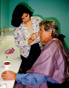 Cinthia a Houston based makeup artist applies makeup to Maury Povich at KHOU 11 for their morning television show.